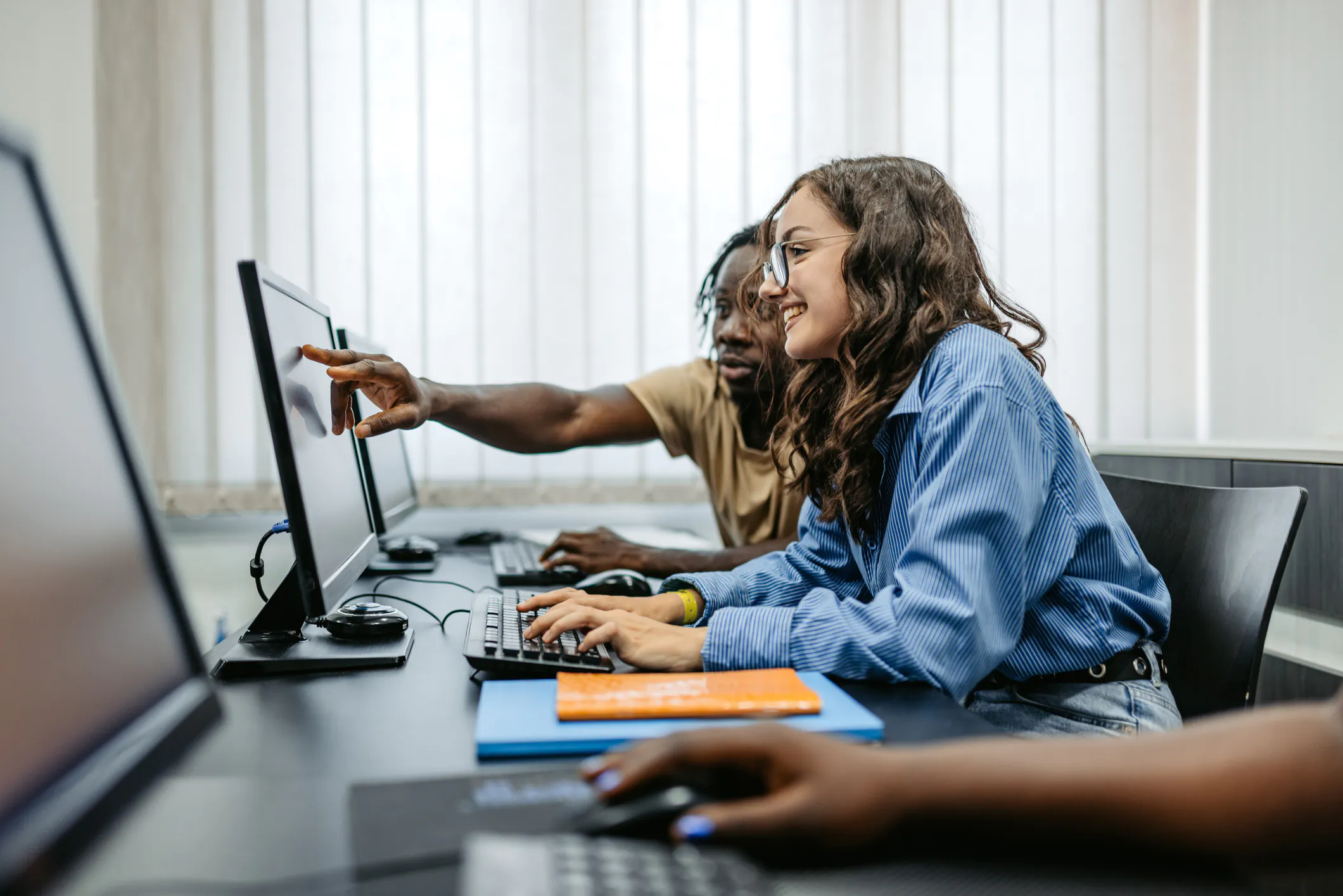 Students working in a group in a programming class to solve a problem.
