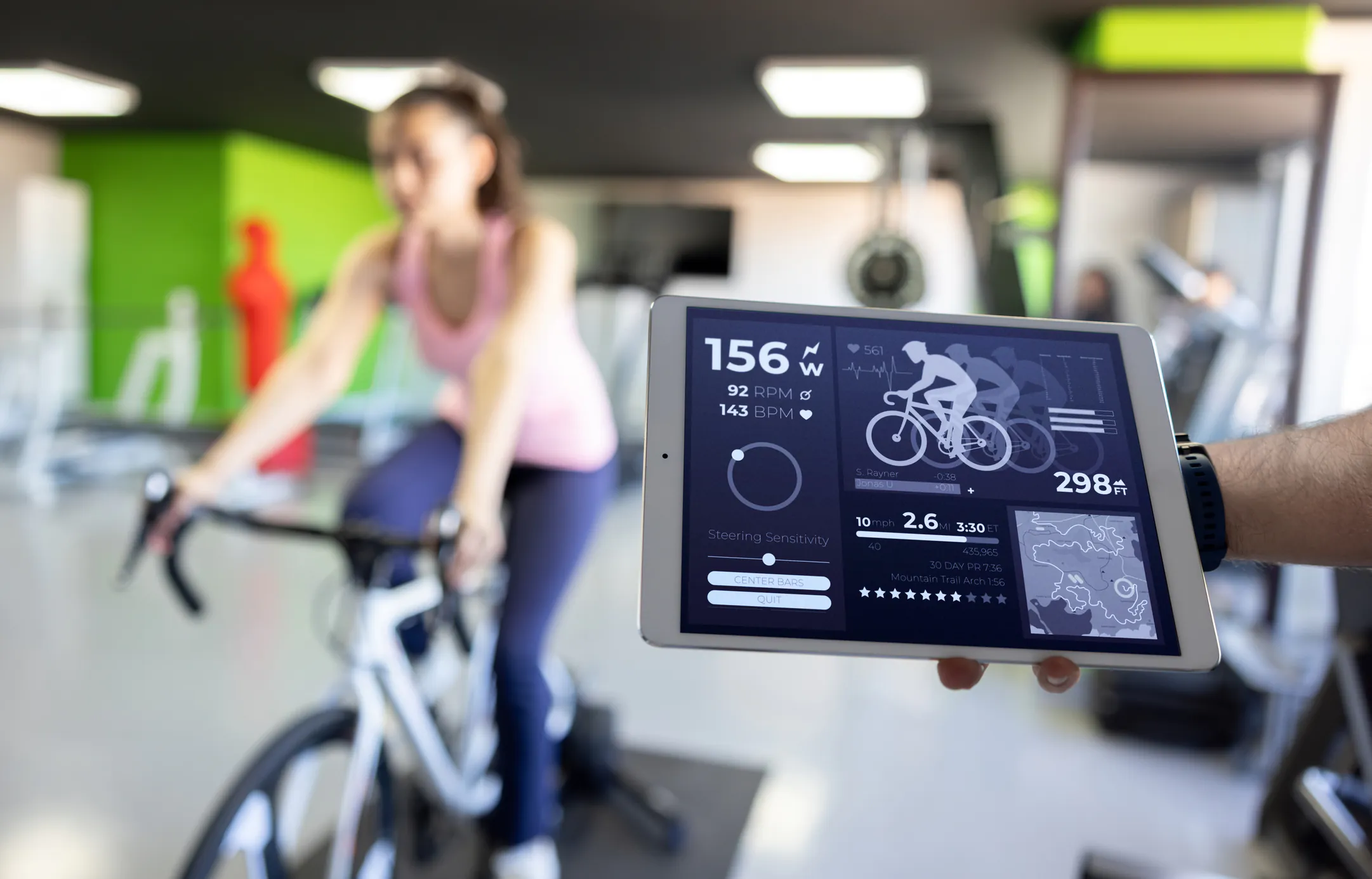 Fit woman taking a stress test while cycling at a health club â healthy lifestyle concepts