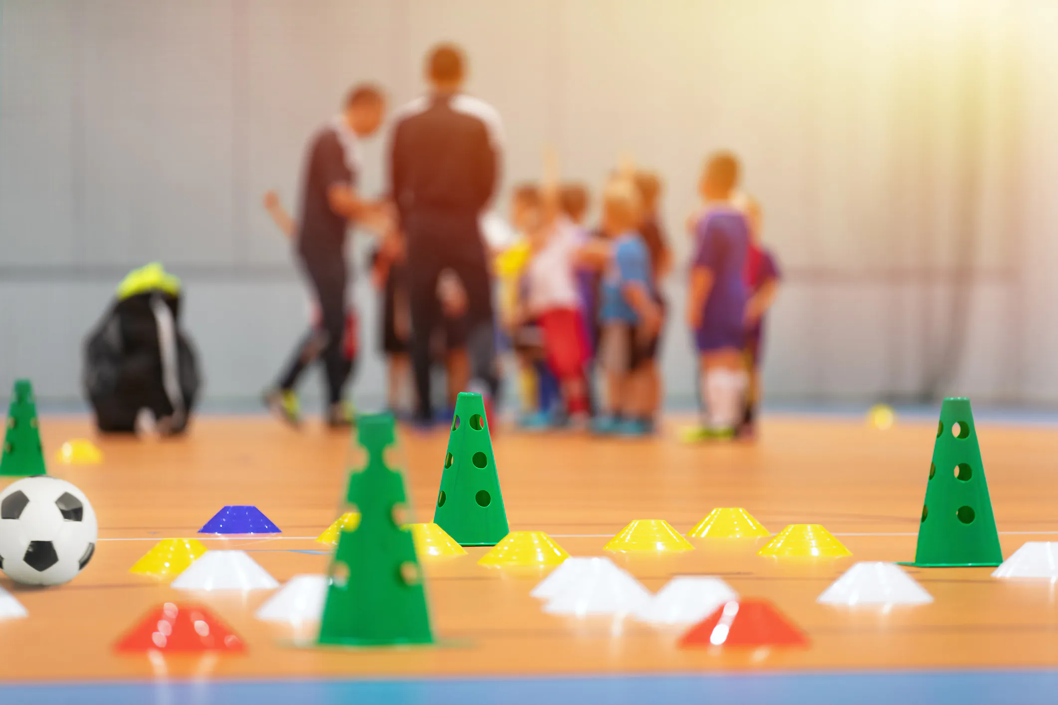 Futsal Soccer Training Court. Kids in a Group With Coaches in Blurred Background. Kids on Physical Education Class at School