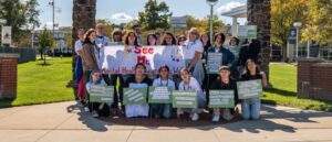 Group of students in front of See Me banner